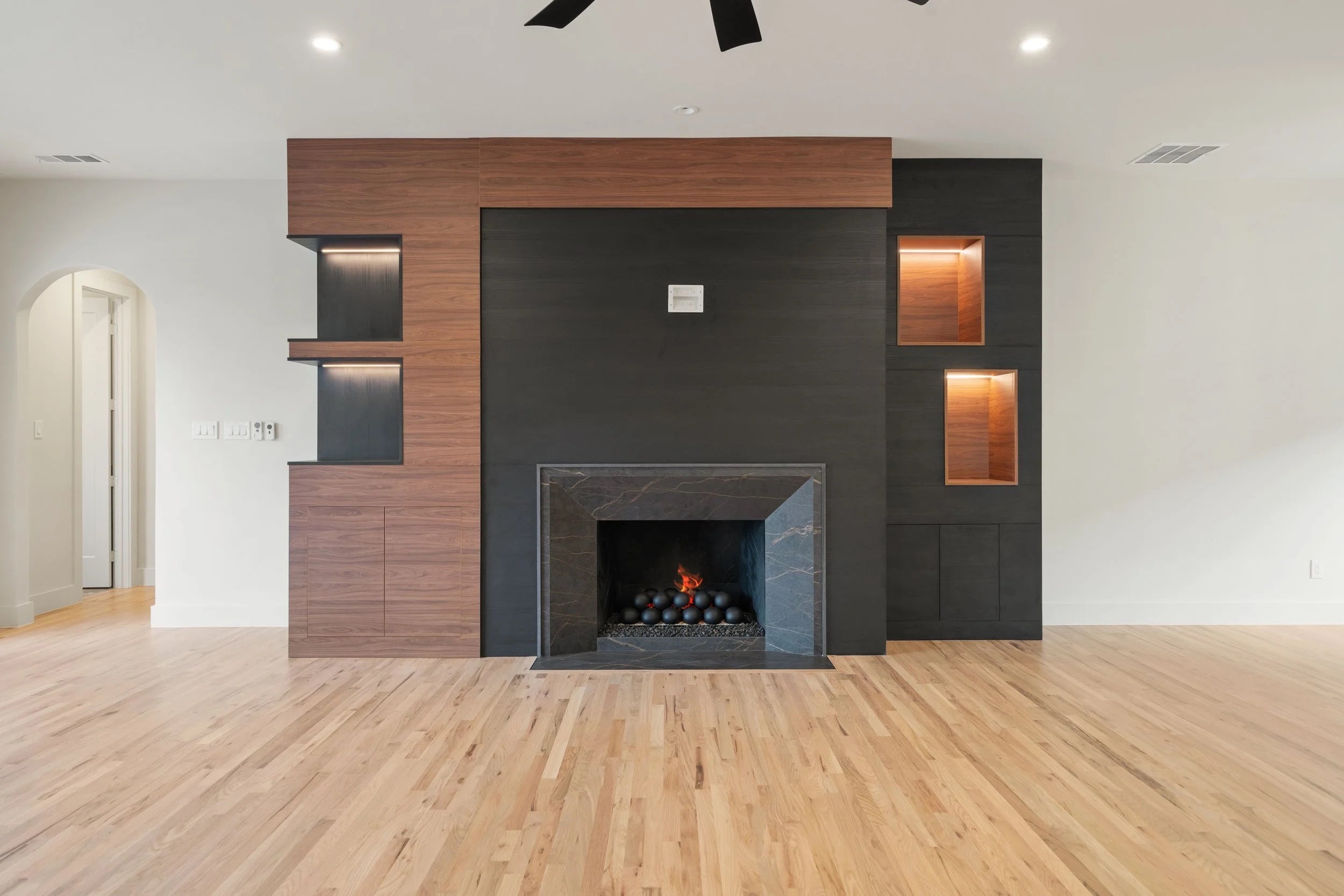 Integrated fireplace wall and cabinetry by Kabeenet