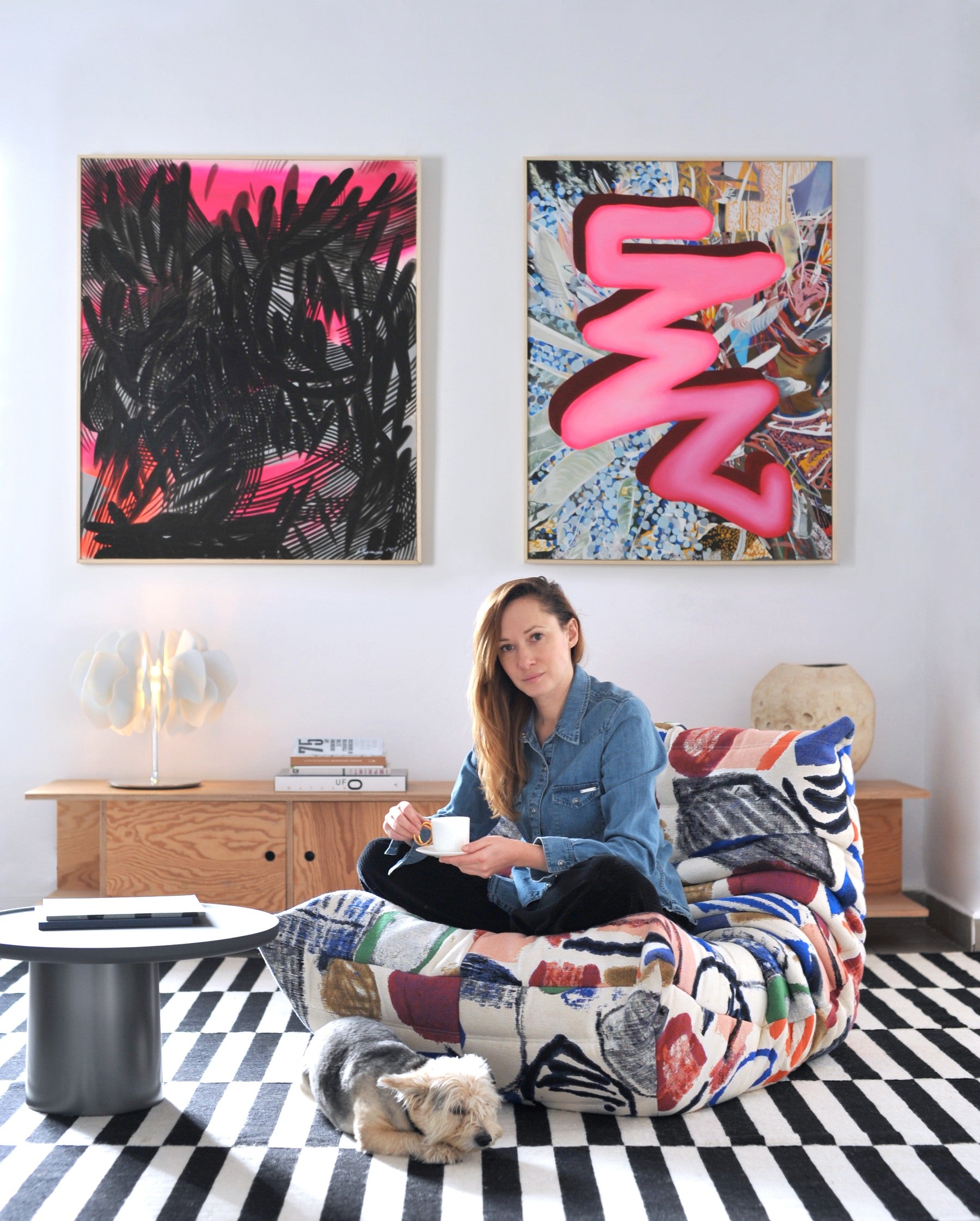 Aleksandra Prusinowska seated beneath her works in her interior