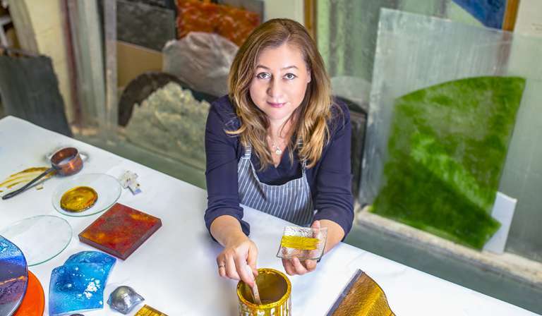 Edyta Barańska working with art glass in her studio